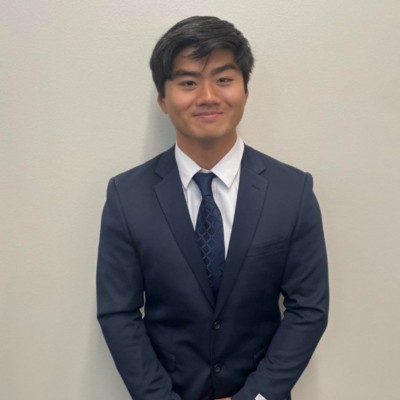 Evan Ren in a navy suit and tie